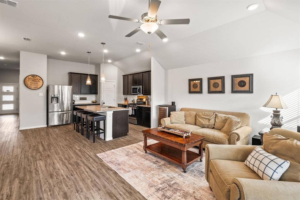 View of living room, kitchen and front hallway