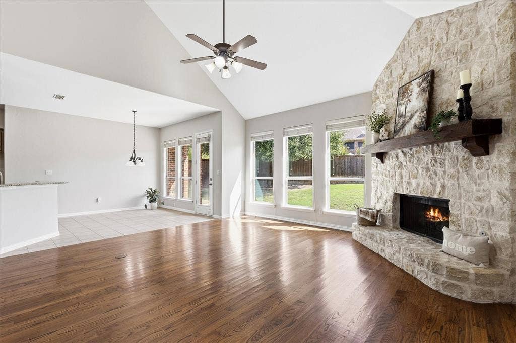 7710 Keith Lane, Sachse, TX 75048 Impressive living room with stone fireplace walla and hearth