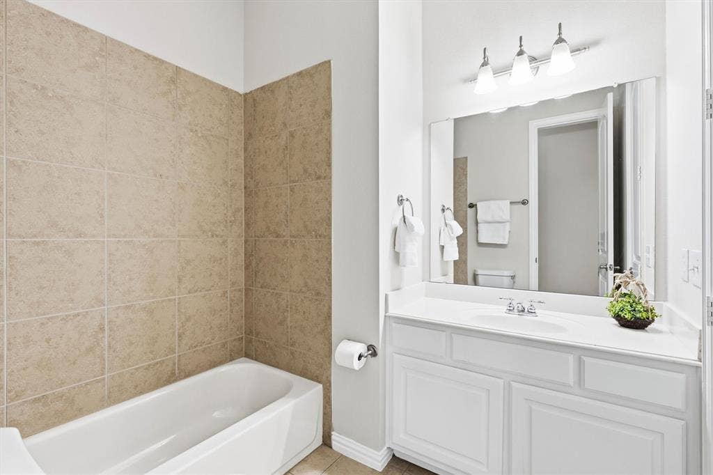 7710 Keith Lane, Sachse, TX 75048 Downstairs full bath with access to both the office and downstairs secondary bedroom