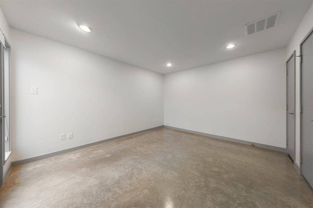 Interior space featuring polished concrete flooring, recessed lighting, and neutral-toned wall paint