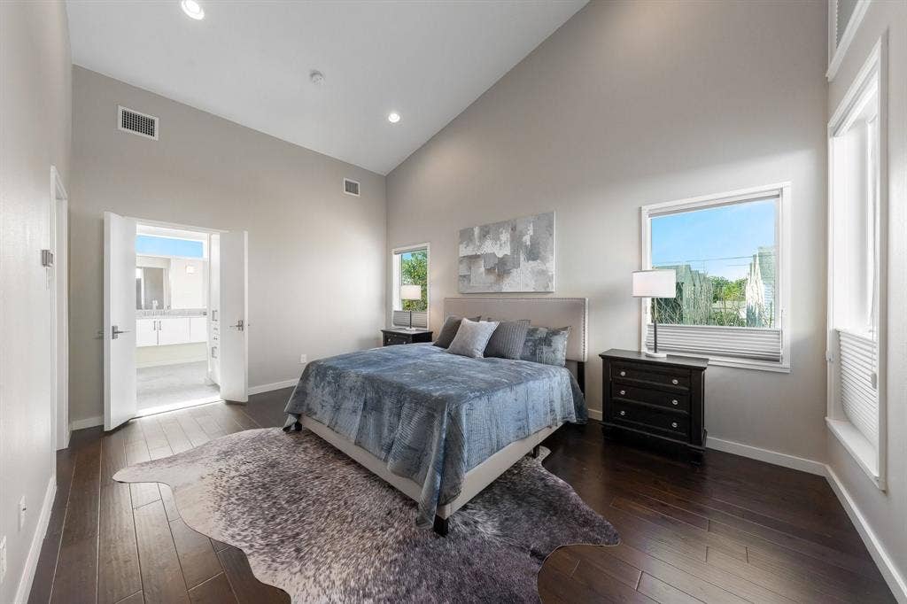 Vaulted ceilings, wood-finish flooring, recessed lighting, and dual windows