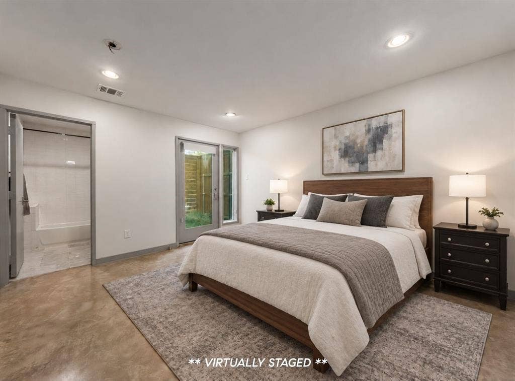 Polished concrete flooring, recessed lighting, and a glass-paneled exterior door
