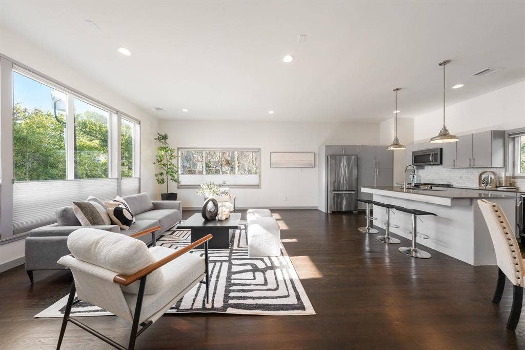 Open-concept interior featuring wood-finish flooring, recessed lighting, and expansive windows