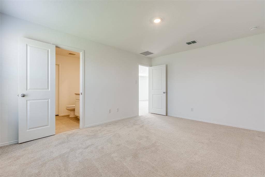 9216 Grackle Place, McKinney, TX 75071 Unfurnished bedroom with ensuite bathroom and light carpet