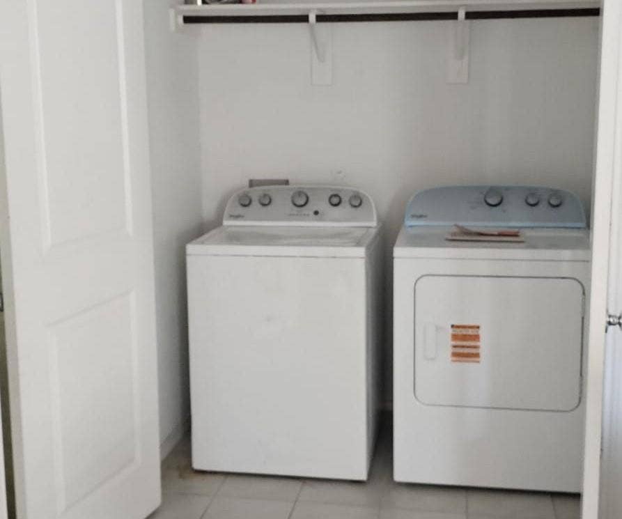 9216 Grackle Place, McKinney, TX 75071 Laundry room featuring light tile patterned floors and washing machine and clothes dryer