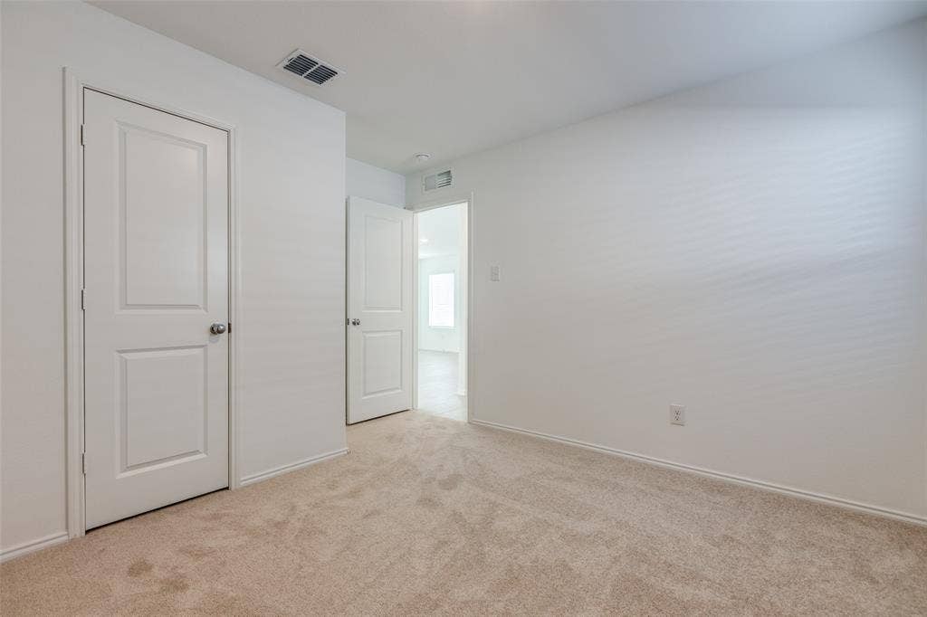 9216 Grackle Place, McKinney, TX 75071 Unfurnished bedroom featuring light carpet