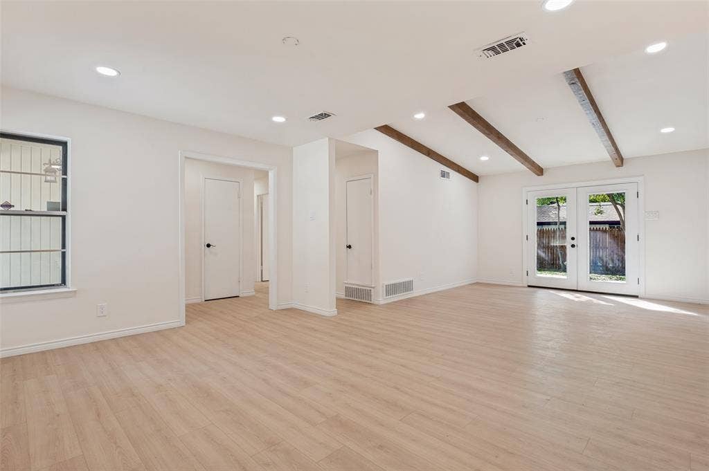 417 Keats Circle, Irving, TX 75061 Open-concept interior featuring light-toned wood-finish flooring, exposed wooden ceiling beams, recessed lighting, and double glass-paned exterior doors