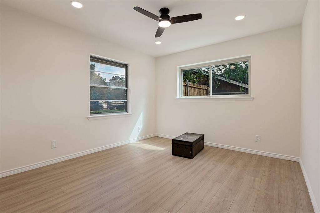 417 Keats Circle, Irving, TX 75061 Room featuring wood-finish flooring, recessed lighting, a modern ceiling fan, and dual windows