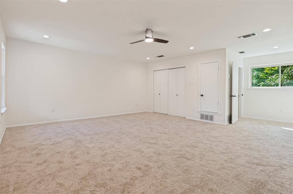 417 Keats Circle, Irving, TX 75061 Spacious interior featuring neutral carpeting, recessed lighting, a modern ceiling fan, and double-door closet storage