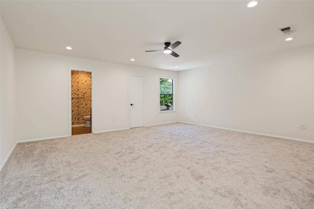 417 Keats Circle, Irving, TX 75061 Neutral-toned carpeting, recessed lighting, ceiling fan with integrated light, and natural light via single-pane window
