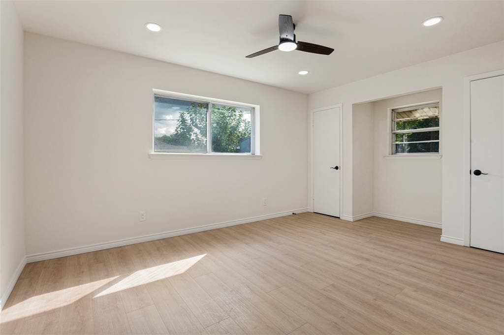 417 Keats Circle, Irving, TX 75061 Interior space featuring wood-finish flooring, recessed lighting, a ceiling fan with integrated lighting, dual windows, and interior doors with matte black hardware