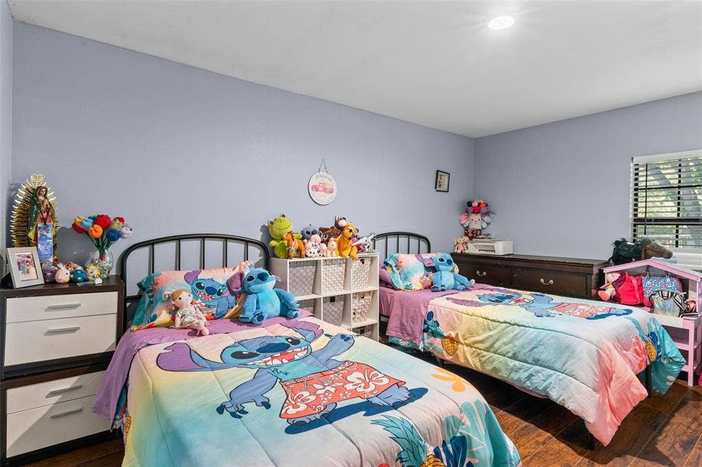 1219 Green Tree Acres Road, Kemp, TX 75143 Bedroom featuring recessed ceiling lighting, a window with horizontal blinds, and wood-finish flooring