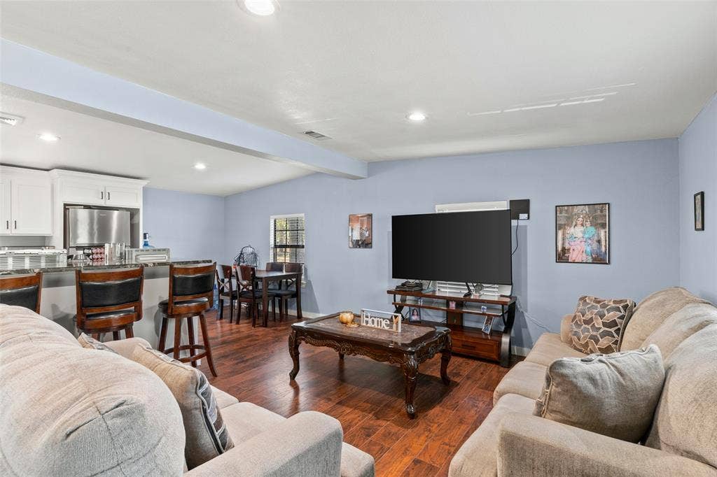 1219 Green Tree Acres Road, Kemp, TX 75143 Open-concept interior featuring wood-finish flooring, recessed lighting, and a kitchen breakfast bar with stone-finish countertops