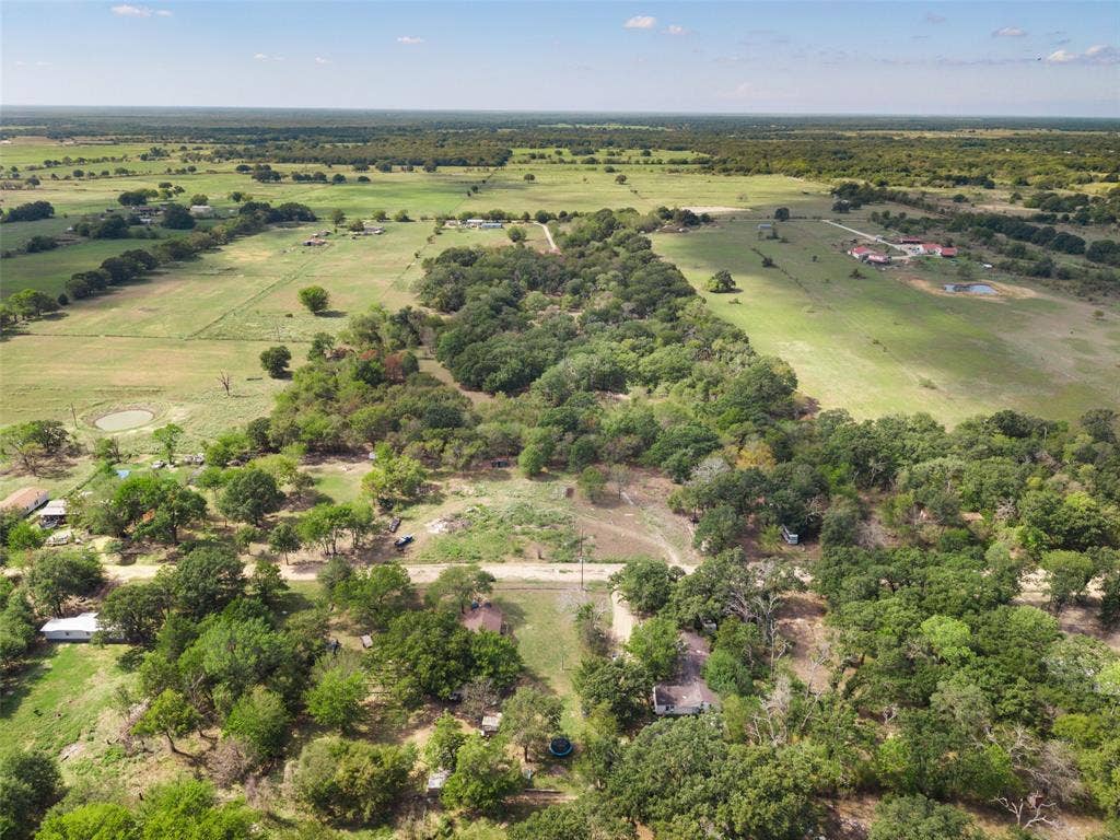 1219 Green Tree Acres Road, Kemp, TX 75143 Aerial perspective of expansive acreage featuring dense clusters of mature trees, open pastureland, and established rural topography