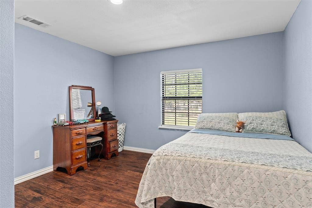 1219 Green Tree Acres Road, Kemp, TX 75143 Interior space featuring wood-finish flooring and a single-hung window with horizontal blinds