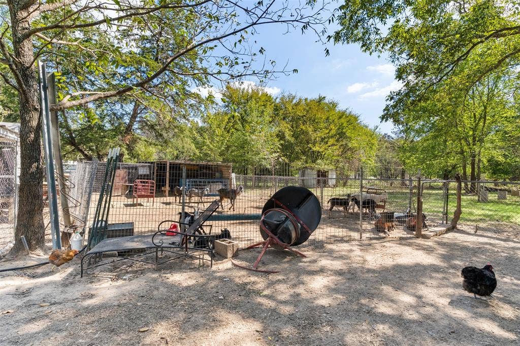 1219 Green Tree Acres Road, Kemp, TX 75143 Fenced exterior area featuring mature trees and a covered livestock structure