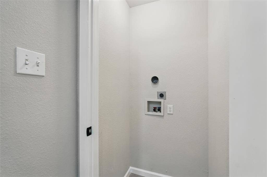 Utility area featuring laundry hookups, dedicated ventilation, and dual toggle light switches