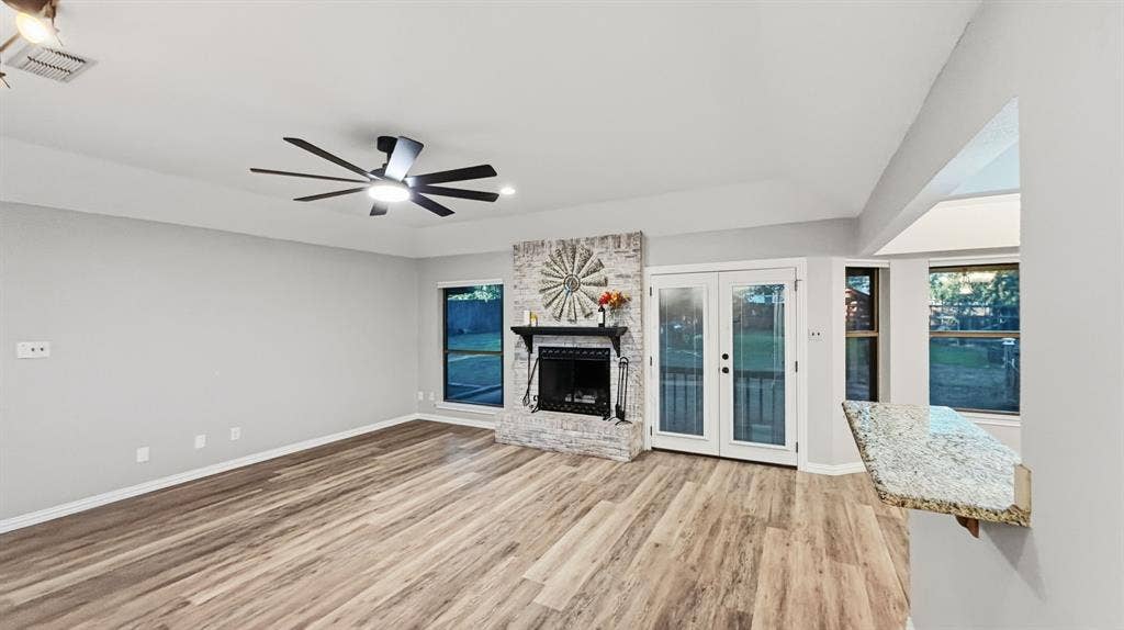 1903 W Spanish Oak Drive, Granbury, TX 76048 Wood burning fireplace and lots of windows!