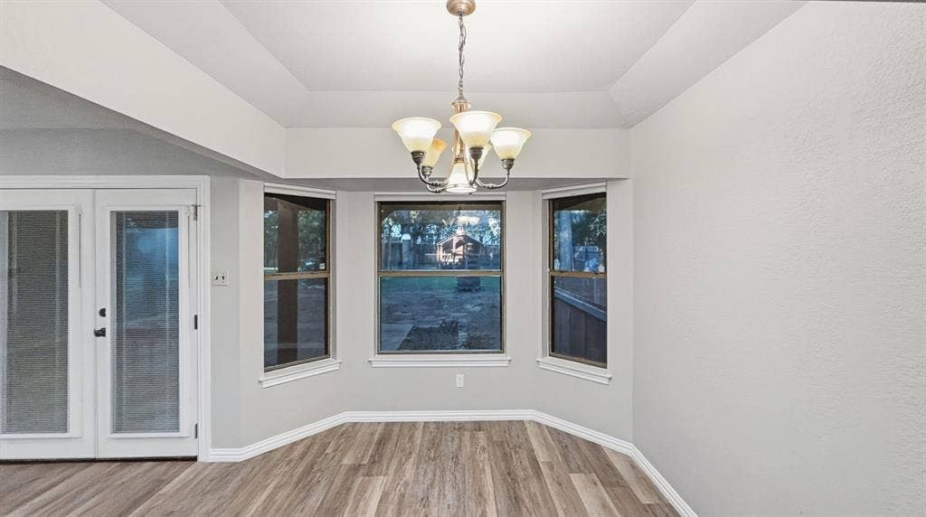 1903 W Spanish Oak Drive, Granbury, TX 76048 Breakfast area with windows to backyard