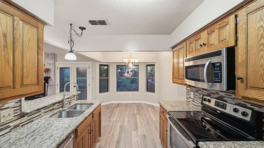 1903 W Spanish Oak Drive, Granbury, TX 76048 Full kitchen view looking out to breakfast area