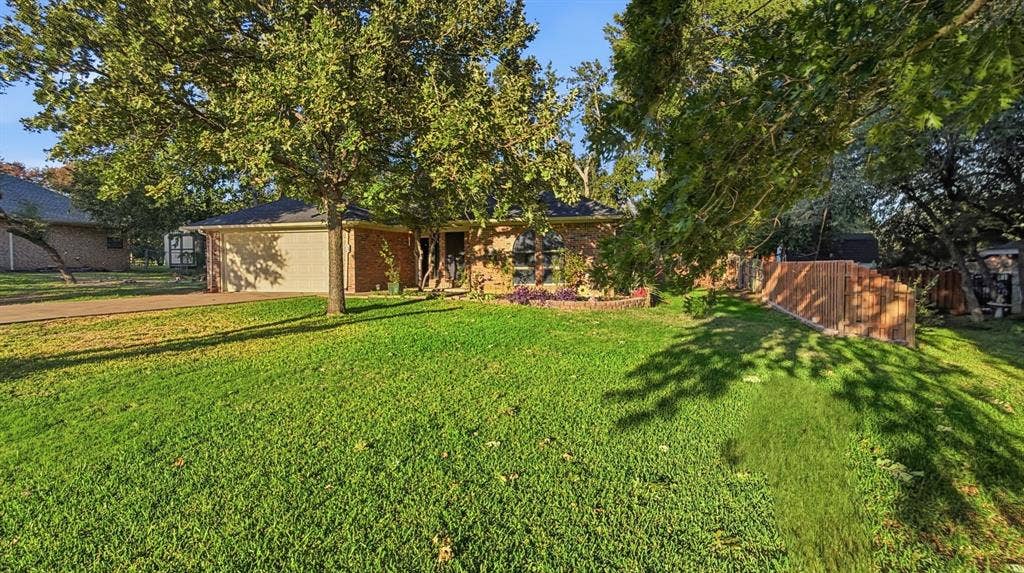 1903 W Spanish Oak Drive, Granbury, TX 76048 Full sod grass and large mature trees!
