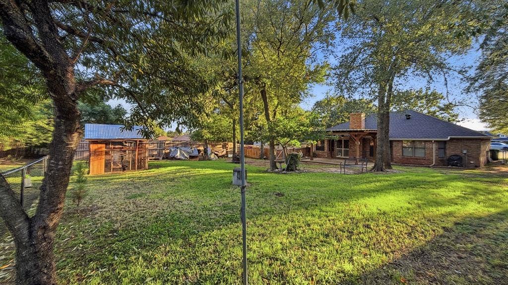 1903 W Spanish Oak Drive, Granbury, TX 76048 Lots of trees, grass, and out buildings