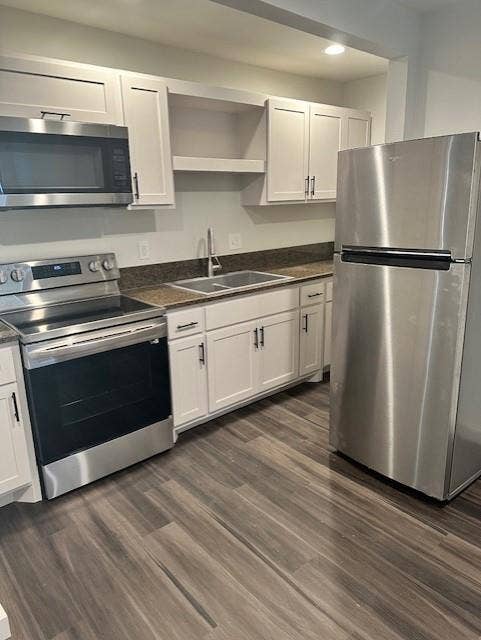 1613 Campbell Street, #A, Commerce, TX 75428 Kitchen featuring white shaker-style cabinetry, stainless steel appliances, stone-surface countertops, dual-basin sink with a gooseneck faucet, and wood-finish flooring