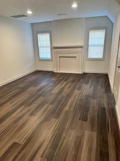 1613 Campbell Street, #A, Commerce, TX 75428 Wood-finish flooring, decorative fireplace mantle, dual windows, and recessed lighting