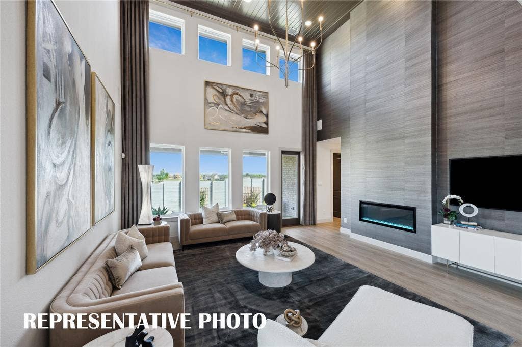 1812 Vetiver Glow Drive, Celina, TX 75009 Dual story windows flood this family room with natural light! REPRESENTATIVE PHOTO