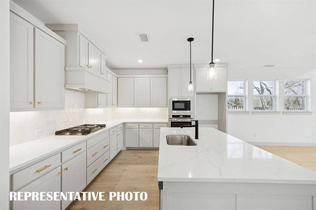 1401 Mistflower Lane, Celina, TX 75009 Beautiful cabinetry, gorgeous countertops and designer backsplash effortlessly pair with contemporary stainless steel to create a kitchen for the ages! REPRESENTATIVE PHOTO