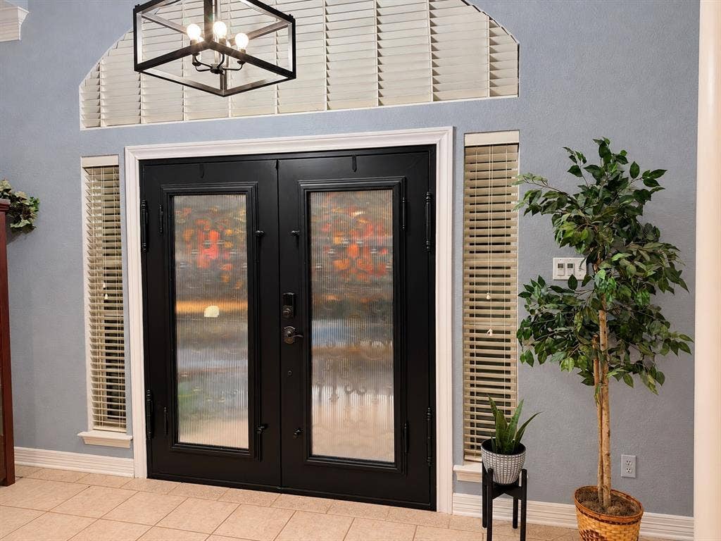 605 Edgewood Lane, Ovilla, TX 75154 Double entry doors with glass panels, arched transom window, and matte black geometric pendant lighting