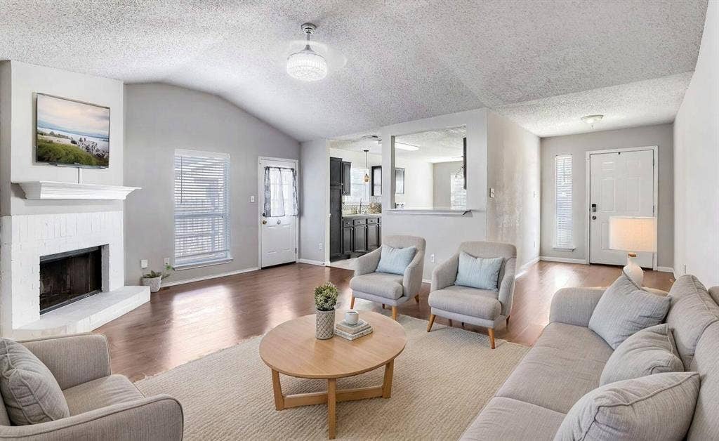 2039 Angelica Way, Dallas, TX 75217 Virtually Staged -Vaulted ceilings, painted brick fireplace with mantel, and wood-finish flooring
