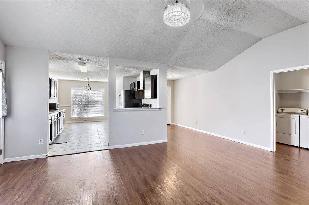 2039 Angelica Way, Dallas, TX 75217 Vaulted ceilings, wood-finish flooring, kitchen pass-through window, and dedicated laundry area
