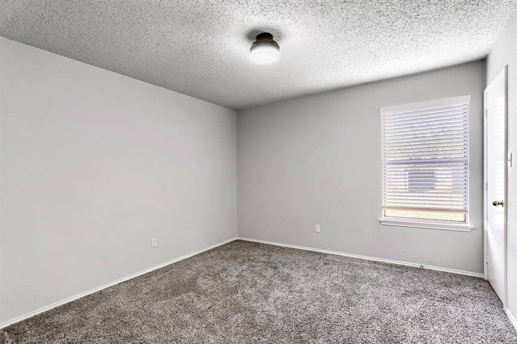 2039 Angelica Way, Dallas, TX 75217 Neutral-toned walls, wall-to-wall carpeting, window with adjustable blinds, and central flush-mount lighting