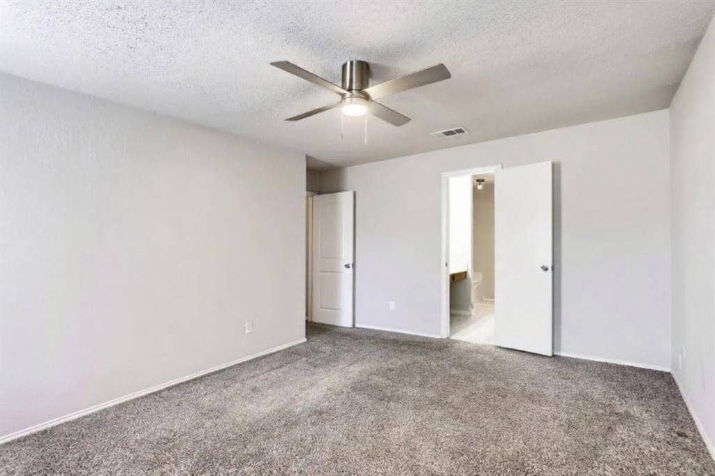 2039 Angelica Way, Dallas, TX 75217 Room featuring neutral-toned carpeting, matte-finish interior walls, and a multi-blade ceiling fan with an integrated light fixture