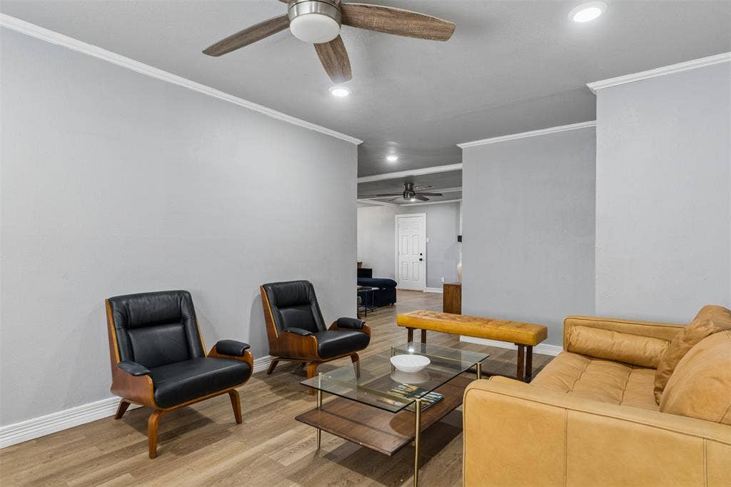 Interior featuring light gray walls, wood-finish flooring, recessed lighting, and a ceiling fan with integrated lighting