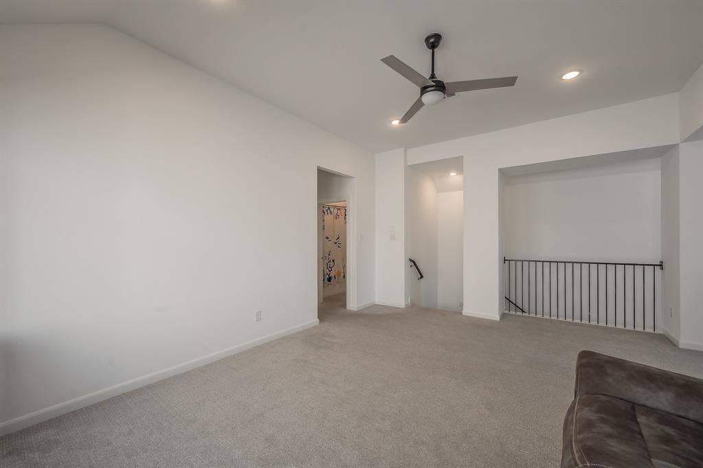 Metal baluster over the stairs, separate from living room downstairs, perfect as a secondary media room, game room, or other