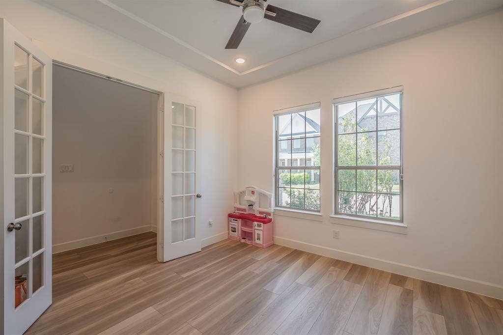 First floor flex room has glass french doors for privacy
