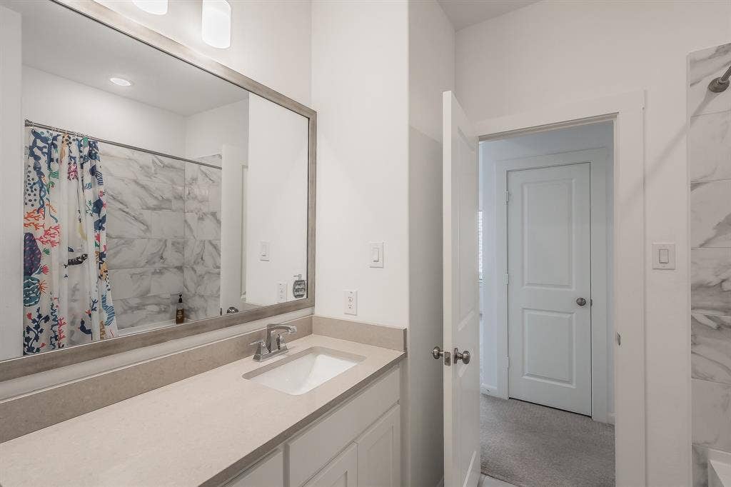 Secondary full bathroom has convenient tub-shower combo