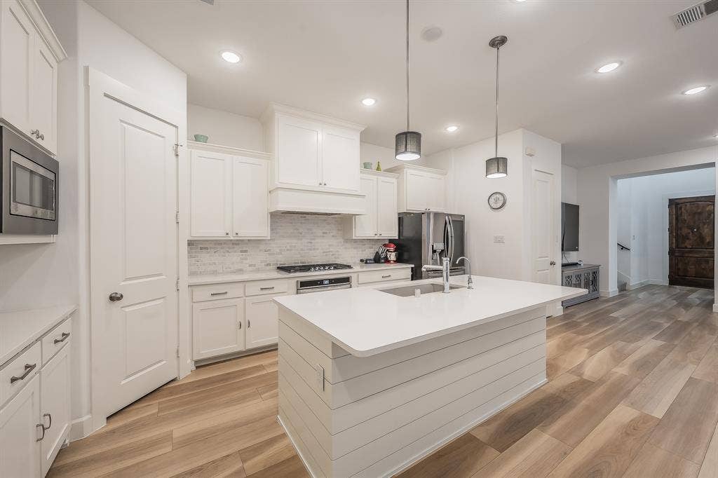 Kitchen layout is exceptional L-shaped with central island and walk in pantry