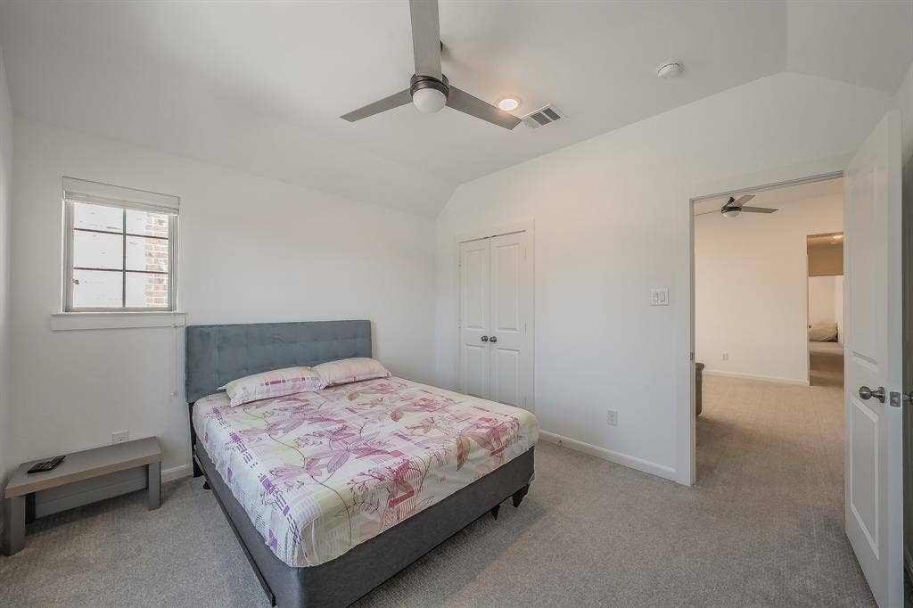 First of 2 secondary bedrooms features a ceiling fan, carpeted flooring and 2 windows for natural light