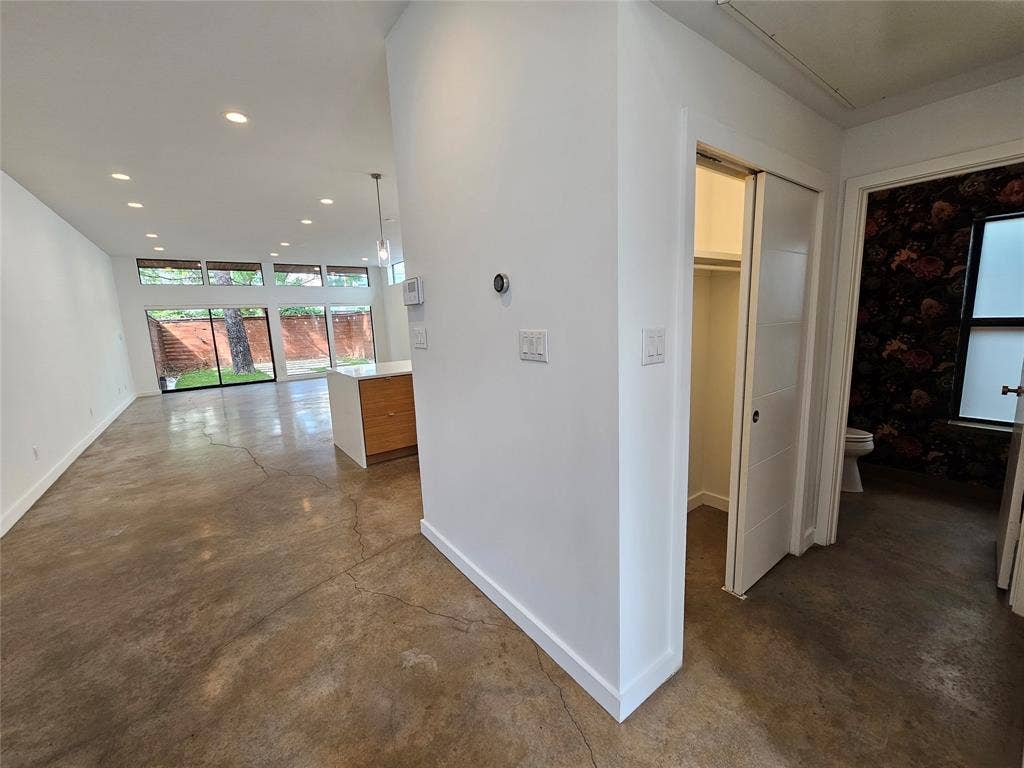 4215 Roseland Avenue, Dallas, TX 75204 Polished concrete flooring, recessed lighting, expansive glass windows, and a sliding door panel system