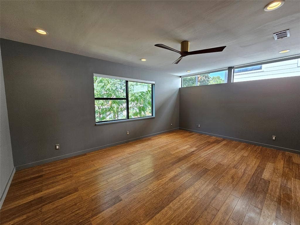 4215 Roseland Avenue, Dallas, TX 75204 Wood-finish flooring, recessed lighting, ceiling fan with metal finish, horizontal clerestory windows, and dark-toned interior wall paint