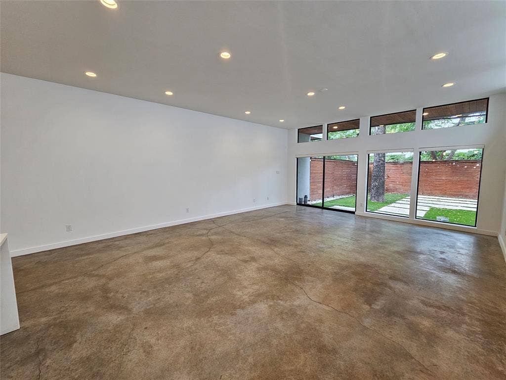 4215 Roseland Avenue, Dallas, TX 75204 Polished concrete flooring, recessed lighting, and expansive floor-to-ceiling windows