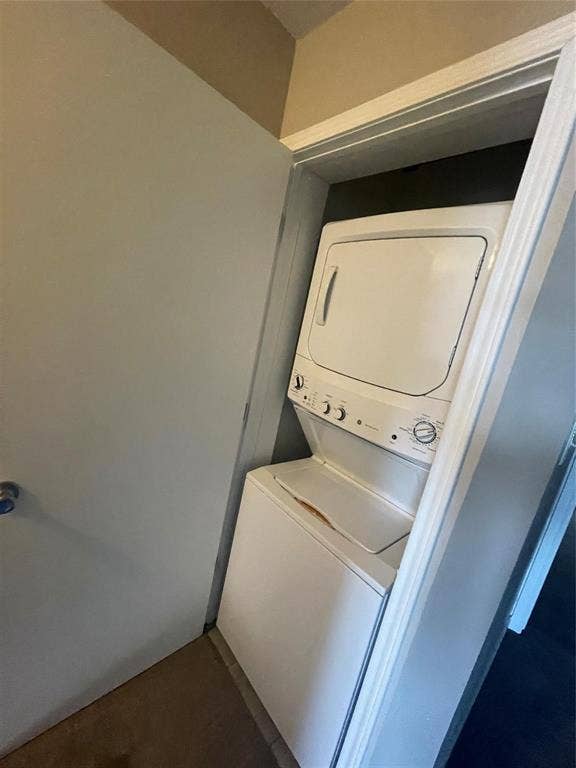 Washroom with stacked washer and clothes dryer