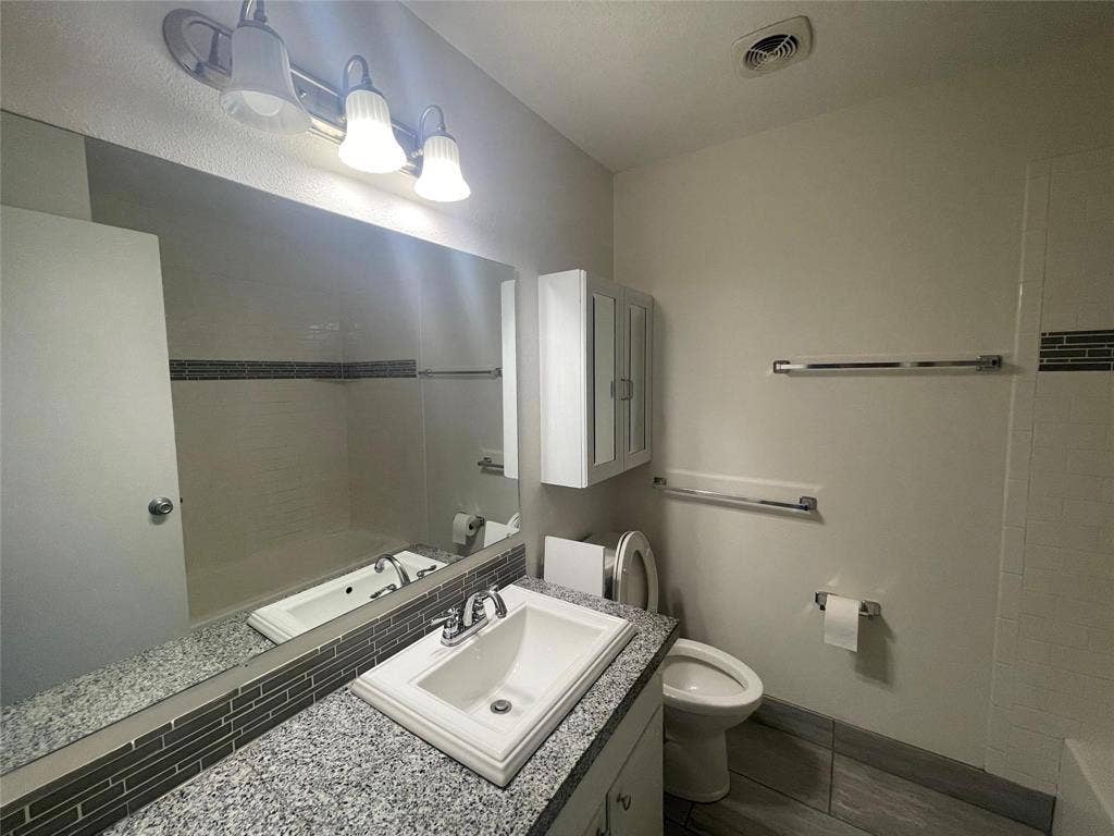 Bathroom with vanity and toilet
