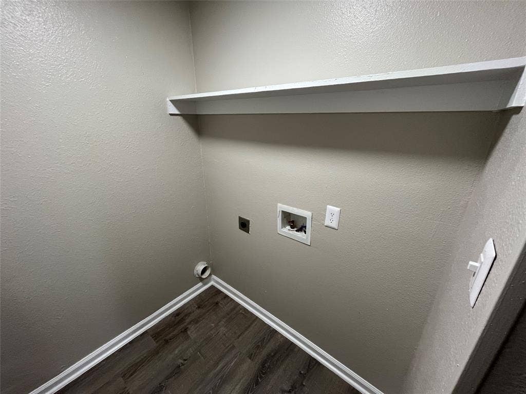 Utility area featuring wood-finish flooring and a built-in floating shelf