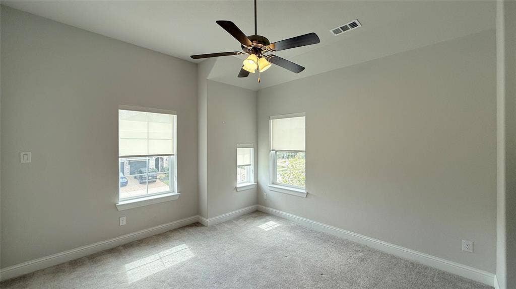 315 Chandan Way, Irving, TX 75063 Neutral wall finishes featuring high ceilings, carpeted flooring, and a multi-blade ceiling fan with an integrated light fixture, punctuated by multi-pane windows