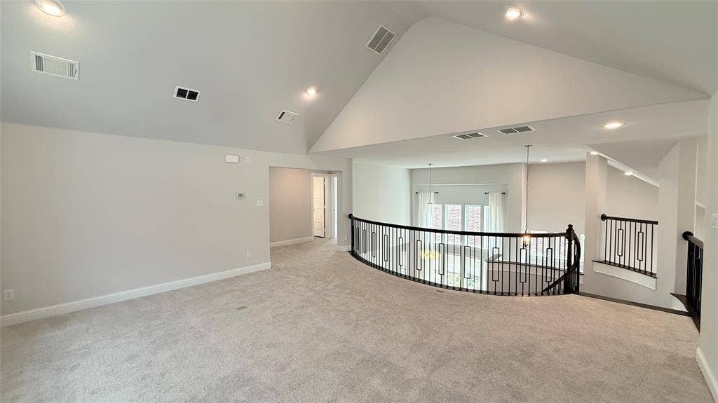 315 Chandan Way, Irving, TX 75063 Vaulted ceilings, carpeted flooring, and decorative metal balustrades
