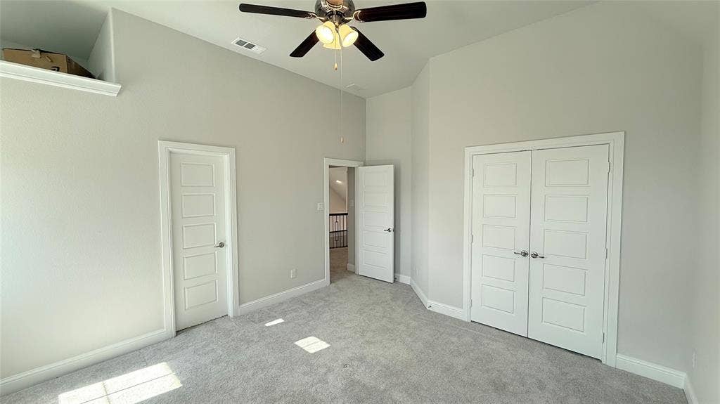 315 Chandan Way, Irving, TX 75063 Vaulted ceilings, neutral carpeting, recessed wall niche, ceiling fan with integrated lighting, and white paneled interior doors